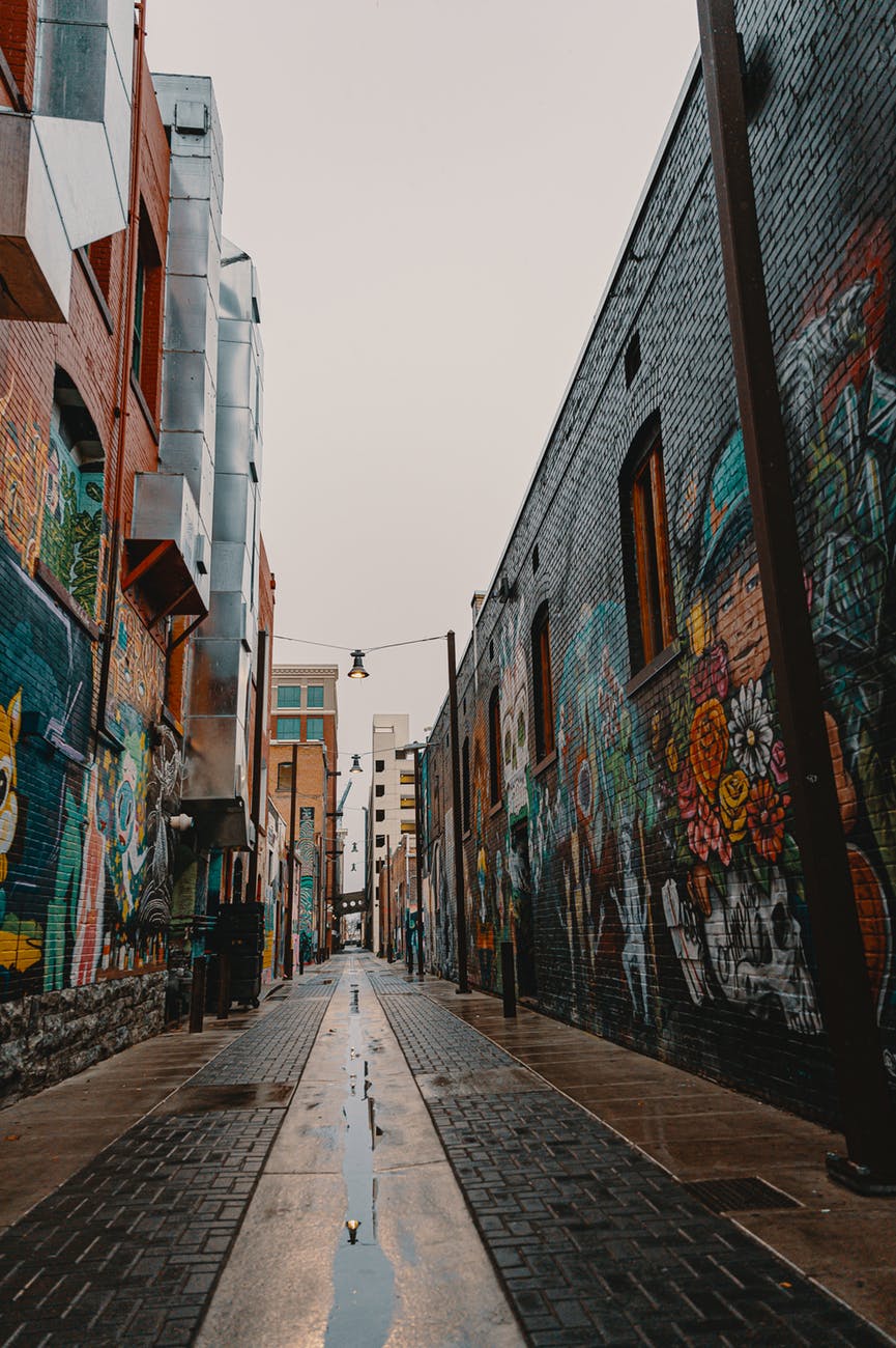 empty street between brown concrete buildings